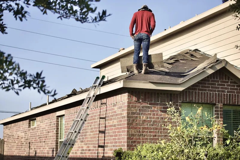 Professional roofer working on a residential roof in Penny Pot